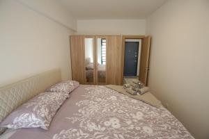 a bedroom with a bed with a teddy bear on it at Apartman Hana Fojnica in Fojnica