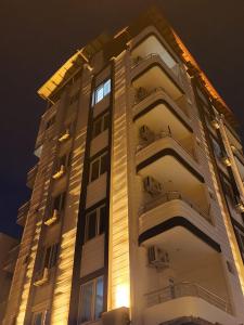 a tall building with lights on the side of it at Almir Otel in Erdemli