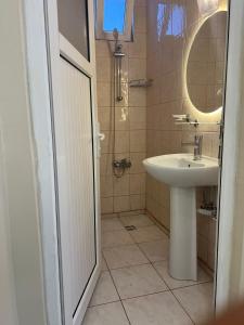 a bathroom with a sink and a mirror at Almir Otel in Erdemli