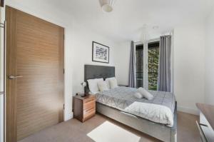 a bedroom with a bed and a wooden door at Luxury Collection - Borough/ Tower Bridge in London