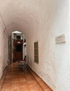 einen Flur mit einem Tisch und einem Stuhl in einem Gebäude in der Unterkunft Vilitsa Holiday House in Pyrgi