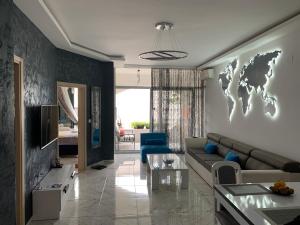 a living room with a couch and a world map on the wall at Sound of the Sea Apartment in Sveti Stefan