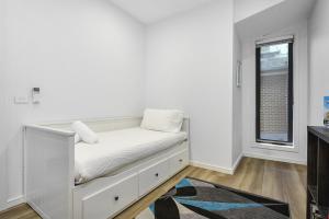 a white room with a bed and a window at Brooklyn Bliss - Amidst Nature's Charm! in Brooklyn