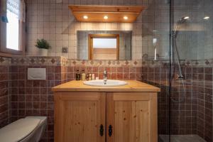 a bathroom with a sink and a shower and a tub at Madame Vacances Chalet L'Arclusaz in Les Allues +18 photos