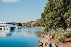 a boat is docked in a large river at Bay Bliss - Coastal Villa in Nelson Bay