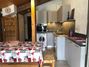 a kitchen with a table and a stove top oven at Atray C3 in Morzine