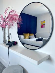 a mirror on a white table in a bedroom at Luxury Norwich City Centre Apartment - Free Parking in Norwich