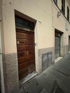 two wooden doors on the side of a building at affittacamere Folignocentro in Foligno