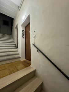 a hallway with stairs and a door in a building at affittacamere Folignocentro in Foligno