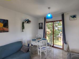 a living room with a blue couch and a table at Albadomus in Denia