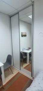 a room with a window and a table and a desk at Capital apartments - CITY CENTRE in Mostar