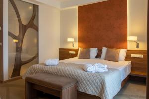 Säng eller sängar i ett rum på Imola Hotel Platán