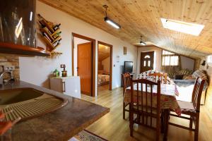 a kitchen and living room with a table and chairs at Samuela Cozy Retreat in Berat