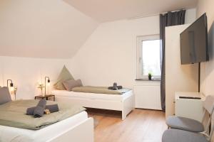 a living room with two beds and a window at Apartment in Witten in Witten