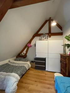 a attic bedroom with two beds and a dresser at Chez Baptistète in Labastide