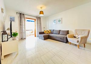 a living room with a couch and a chair at Sea view apartment in Los Cristianos in Arona