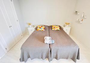 a bedroom with a bed with two towels on it at Sea view apartment in Los Cristianos in Arona +16 photos