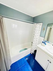 a bathroom with a tub and a sink at Sea view apartment in Los Cristianos in Arona