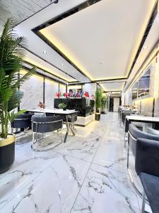 a restaurant with marble floors and tables and chairs at Taksim Larissa hotel suites in Istanbul
