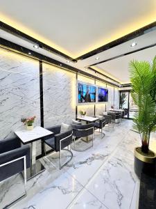 a restaurant with marble walls and tables and chairs at Taksim Larissa hotel suites in Istanbul