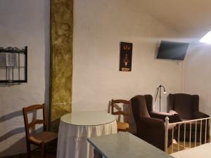 a living room with chairs and a table and a couch at Apartamentos Rurales Candela in Cañamero