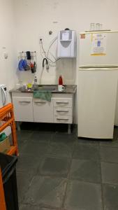 a kitchen with a refrigerator and a sink at COACHHOSTEL7 in Sao Paulo