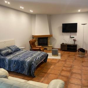 a bedroom with a bed and a flat screen tv at Bakio Beach House in Bakio