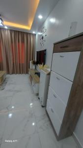 a kitchen with white appliances in a room at Eamar tower 2 in Tanta