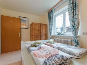 a bedroom with two beds and a window at Holiday Home Bergfried - FUC150 by Interhome in Fusch an der Glocknerstraße