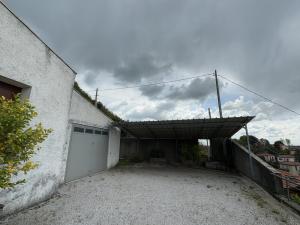 a garage with a white garage door and a building at Residence Rossini in Tavernerio
