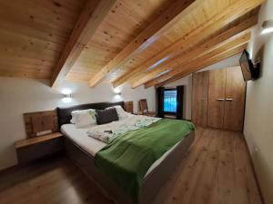a large bed in a room with wooden ceilings at Apartment Lehen by Interhome in Thierbach