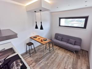 a living room with a couch and a table at Green Land Boutique Hotel in Castilenti