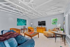 een woonkamer met een blauwe bank en een tafel bij Go to the beach from expansive heated pool home in Fort Myers Beach