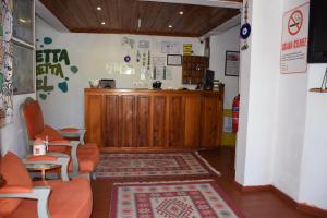 a waiting room with orange chairs and a counter at Caretta Caretta Hotel in Dalyan