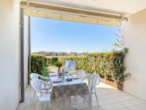 a patio with a table and chairs on a balcony at Apartment Les Pêcheurs-4 by Interhome in Mimizan-Plage