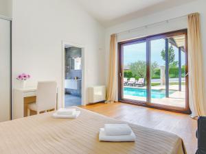 a bedroom with a bed and a view of a pool at Villa Luna Rossa by Interhome in Sveti Petar u Šumi