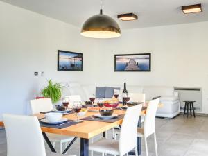 a dining room with a wooden table and white chairs at Villa Luna Nera by Interhome in Sveti Petar u Šumi