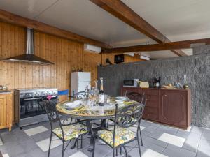 a dining room with a table and chairs in a kitchen at Studio Serena by Interhome in Piedimonte Etneo +19 photos