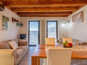 een woonkamer met een tafel en een bank bij Holiday Home Marcello by Interhome in Sueglio
