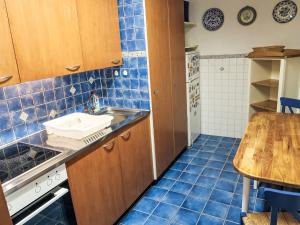 a small kitchen with a sink and a table at Apartment Utoring Acletta-123 by Interhome in Disentis