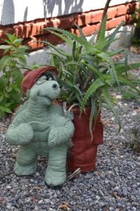 a statue of a potted plant sitting next to a plant at Caretta Caretta Hotel in Dalyan