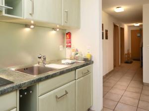 a kitchen with a sink and a counter top at Apartment Belmi by Interhome in Zweisimmen