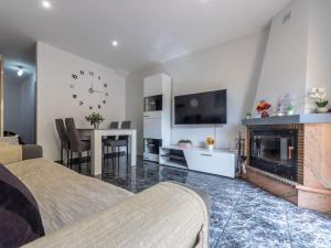 a bedroom with a fireplace and a dining room at Holiday Home Llaberia by Interhome in Torredembarra