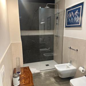a bathroom with a shower with a toilet and a sink at Kemani Villa Sara Olbia in Olbia