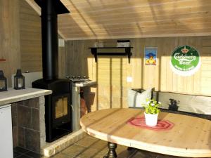 a kitchen with a wood stove and a wooden table at Holiday Home Trondbu - SOW106 by Interhome in Madland