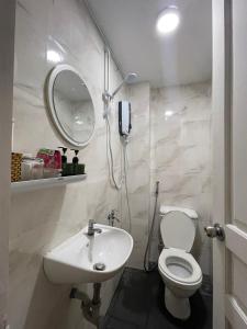 a bathroom with a sink and a toilet and a mirror at Jasmine Hotel in Ho Chi Minh City