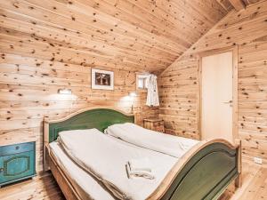 a bedroom with a bed in a wooden cabin at Holiday Home Veganeset I - FJS294 by Interhome in Balestrand