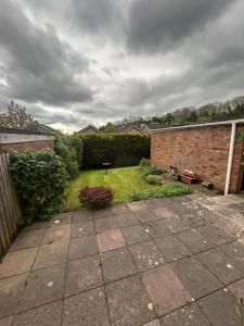 a backyard with a brick wall and a yard at Number 10 in Chepstow