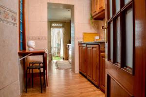 a kitchen with a table and a chair in a room at Live Oporto Rooms in Porto