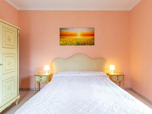a bedroom with a bed with two nightstands and two lamps at Apartment Mila by Interhome in Colico